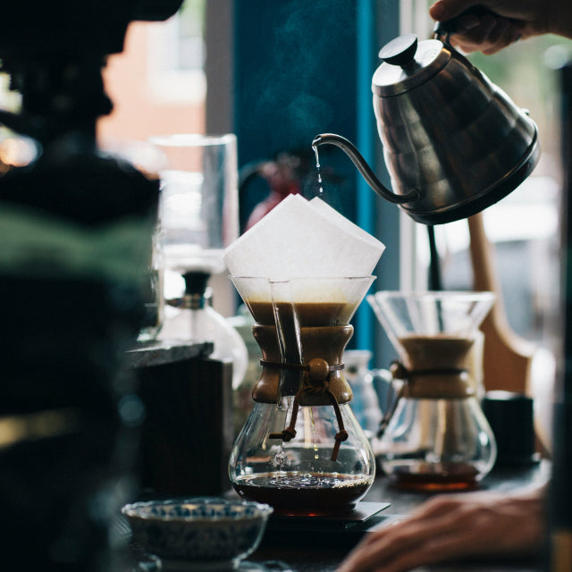 Pour-over coffee being brewed with a gooseneck kettle